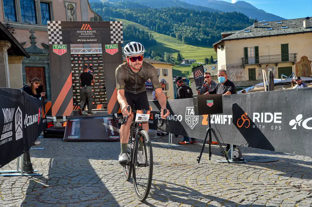 Tom Cooling riding across the cobbles at a Haute Route Dolomites stage start
