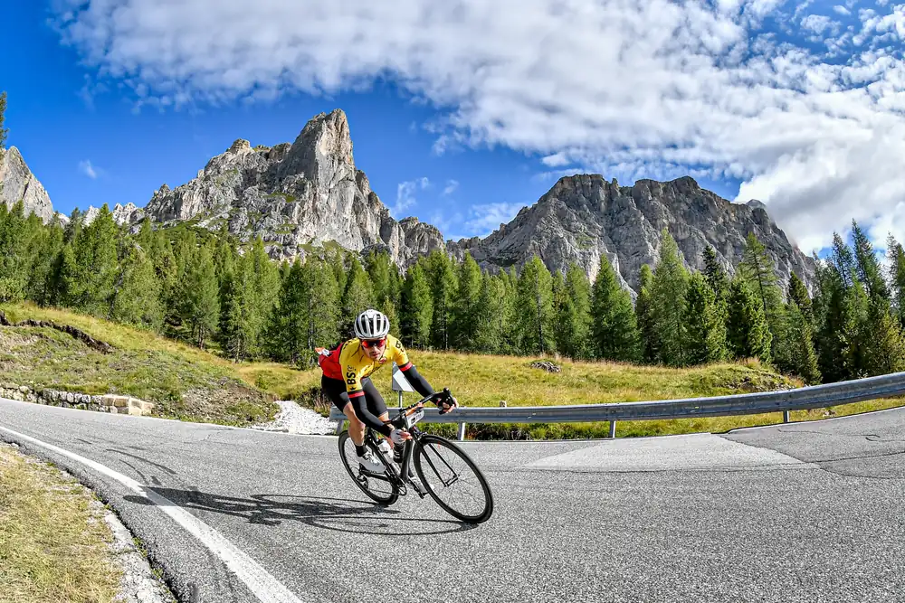 Tom Cooling descending a Dolomites pass below jagged peaks at the Haute Route Dolomites