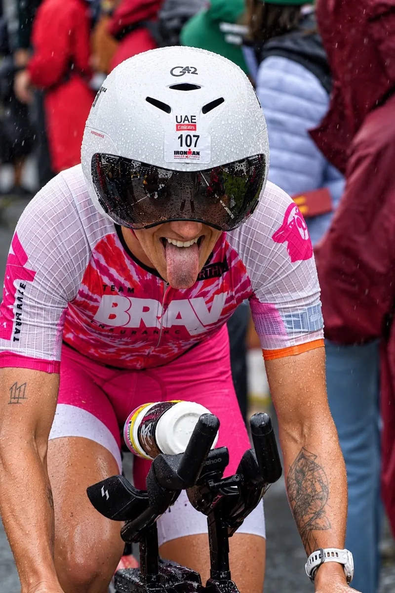 Madison S riding her time trial bike in the wet at Ironman Wales on the way to an age group course record