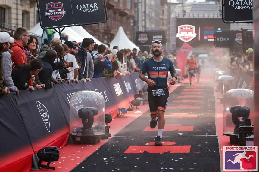 A Horsepower athlete in branded kit finishing IRONMAN Hamburg
